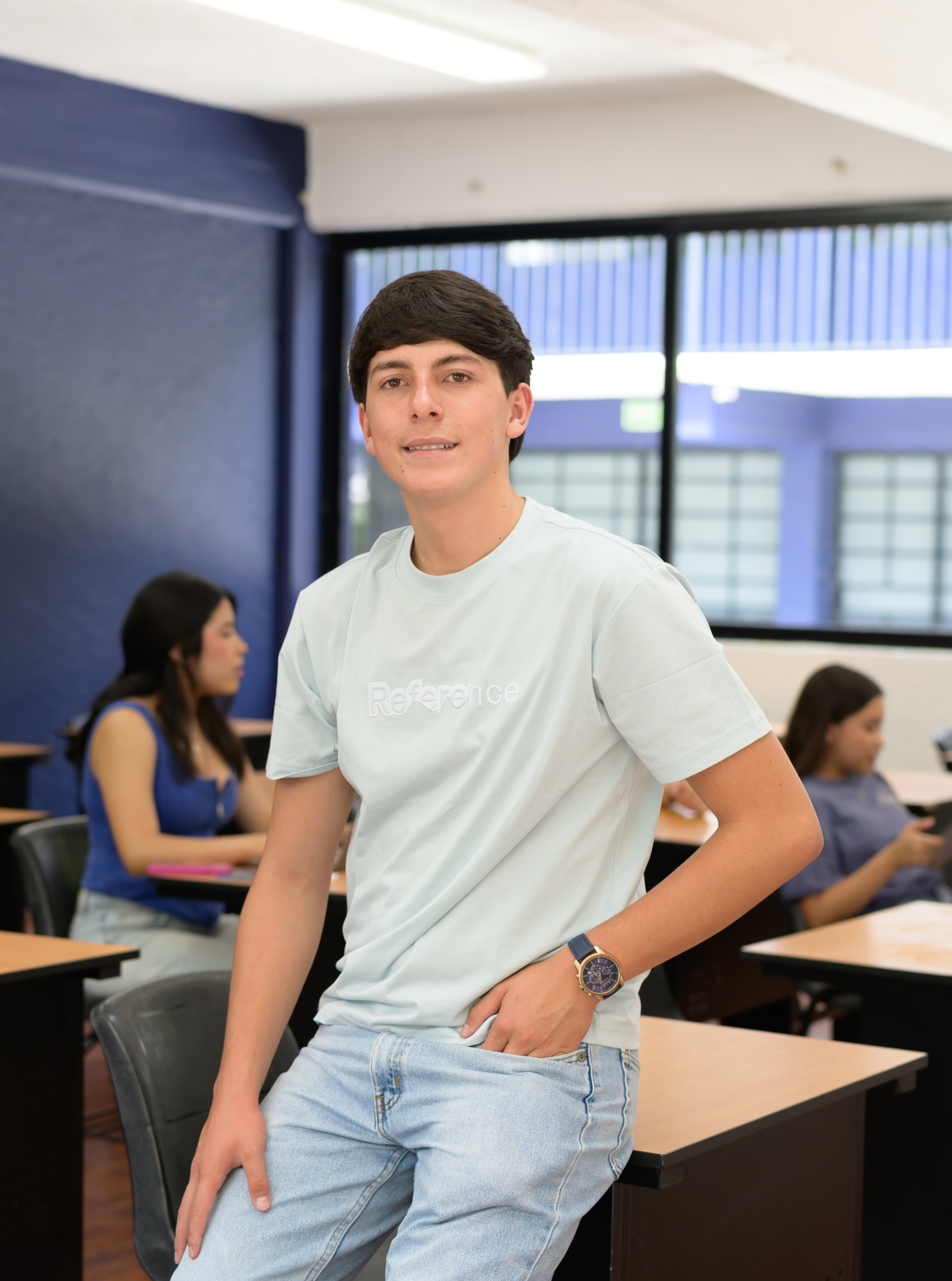Estudiante de pie en un salón del campus